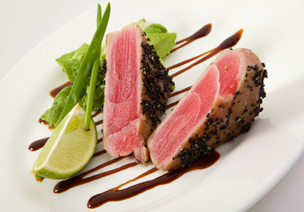 Seared tuna with lime and sauce drizzle.