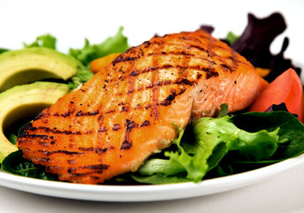Grilled salmon salad with avocado and greens.