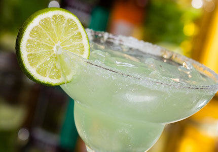 Margarita cocktail with lime and salted rim.