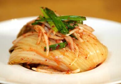 Spicy kimchi on a white plate.