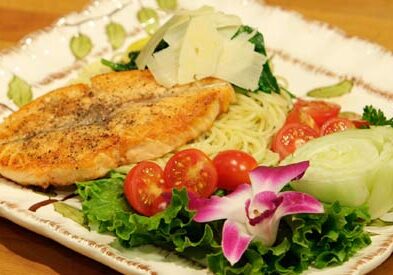 Grilled salmon with pasta and vegetables.