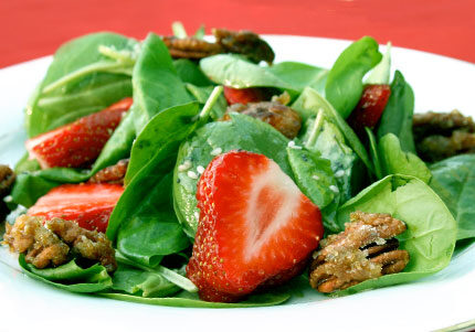 Spinach salad with strawberries and pecans.