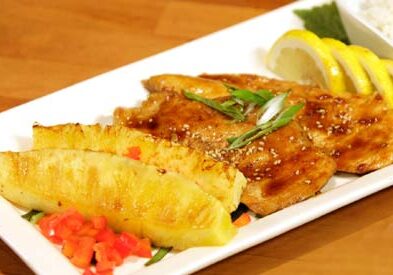 Grilled chicken with pineapple and lemon slices.